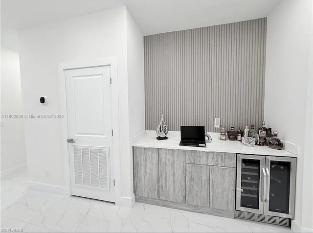 2838NW Embers Ter, Cape Coral, FL 33993 - indoor dry bar featuring wine cooler, light marble finish floors, and baseboards