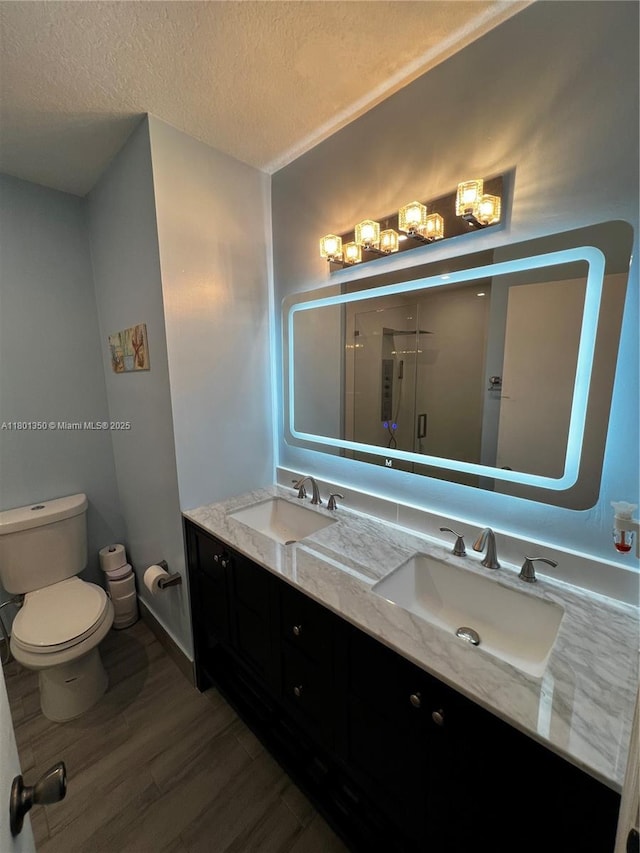 6014 SW 162nd Pl, Miami, FL 33193 - bathroom featuring double vanity, wood finished floors, a stall shower, and a textured ceiling