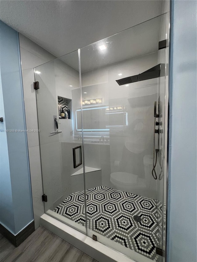 6014 SW 162nd Pl, Miami, FL 33193 - full bathroom with wood finished floors, a shower stall, and a textured ceiling