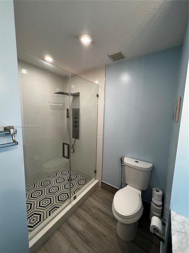 6014 SW 162nd Pl, Miami, FL 33193 - full bath featuring wood finished floors, a stall shower, and a textured ceiling