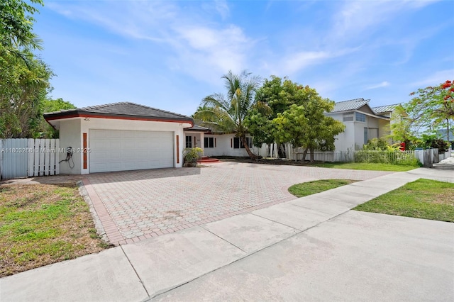 3161 SW 138th Ave, Miami, FL 33175 - single story home featuring an attached garage, decorative driveway, fence, and stucco siding