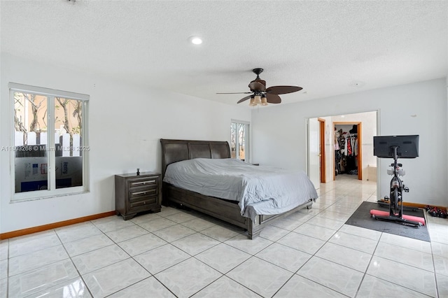 3161 SW 138th Ave, Miami, FL 33175 - bedroom featuring a textured ceiling, a spacious closet, baseboards, light tile patterned flooring, and a closet