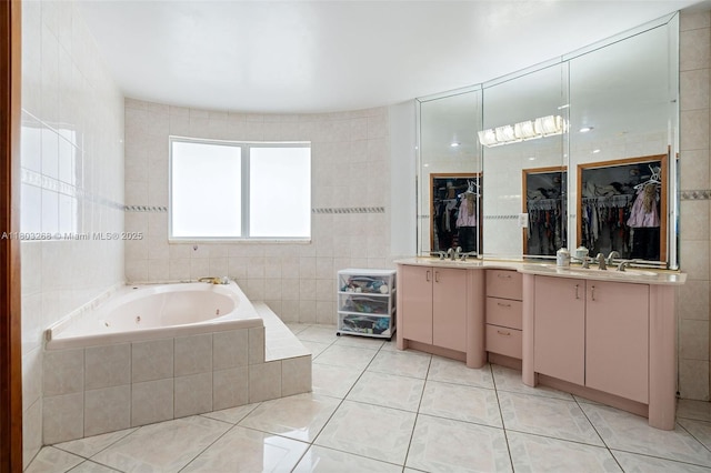 3161 SW 138th Ave, Miami, FL 33175 - bathroom featuring tile patterned floors, a jetted tub, a spacious closet, tile walls, and vanity