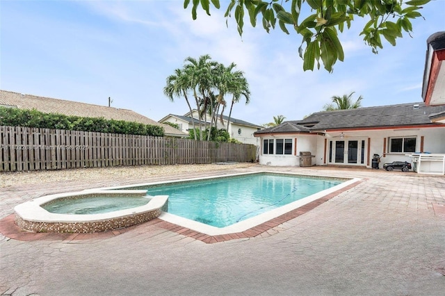 3161 SW 138th Ave, Miami, FL 33175 - view of swimming pool featuring french doors, a patio, a fenced backyard, and a pool with connected hot tub