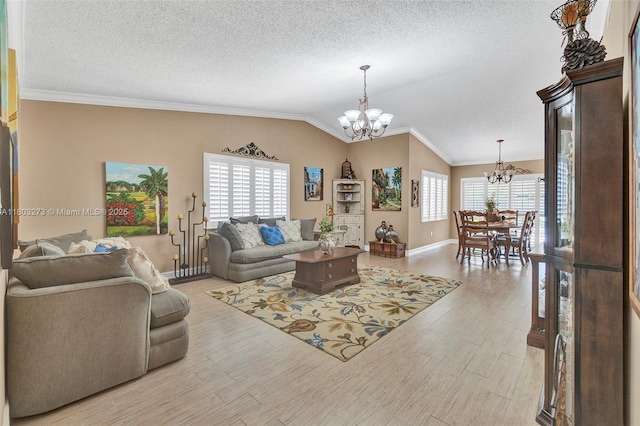 13338 SW 8th Ln, Miami, FL 33184 - living room with a chandelier, light wood-style floors, lofted ceiling, ornamental molding, and a textured ceiling