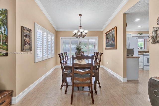 13338 SW 8th Ln, Miami, FL 33184 - dining area with a chandelier, a textured ceiling, light wood-style floors, and crown molding