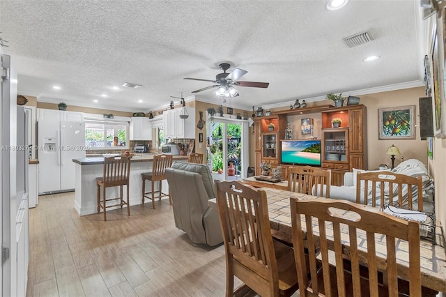 13338 SW 8th Ln, Miami, FL 33184 - dining space with ornamental molding, healthy amount of natural light, ceiling fan, a textured ceiling, and light wood-style flooring