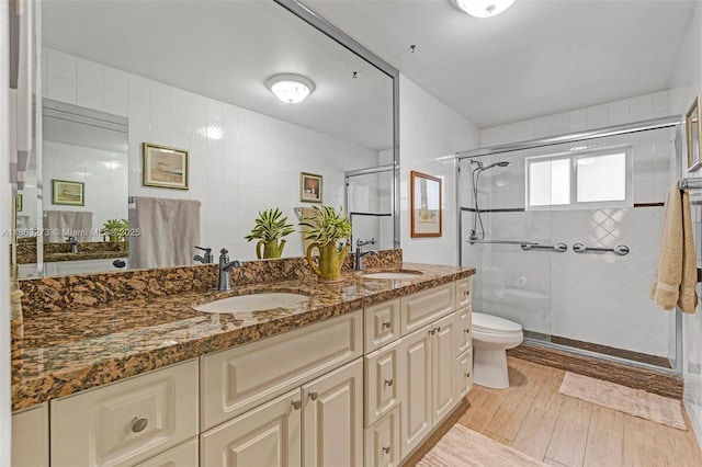 13338 SW 8th Ln, Miami, FL 33184 - full bath with double vanity, wood finished floors, a stall shower, and tile walls