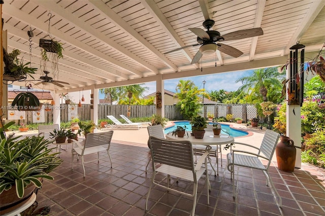 13338 SW 8th Ln, Miami, FL 33184 - fenced backyard with ceiling fan, a patio area, and outdoor dining space