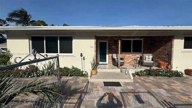 111 SW 24th Ave, Miami, FL 33135 - entrance to property featuring covered porch, stucco siding, and brick siding
