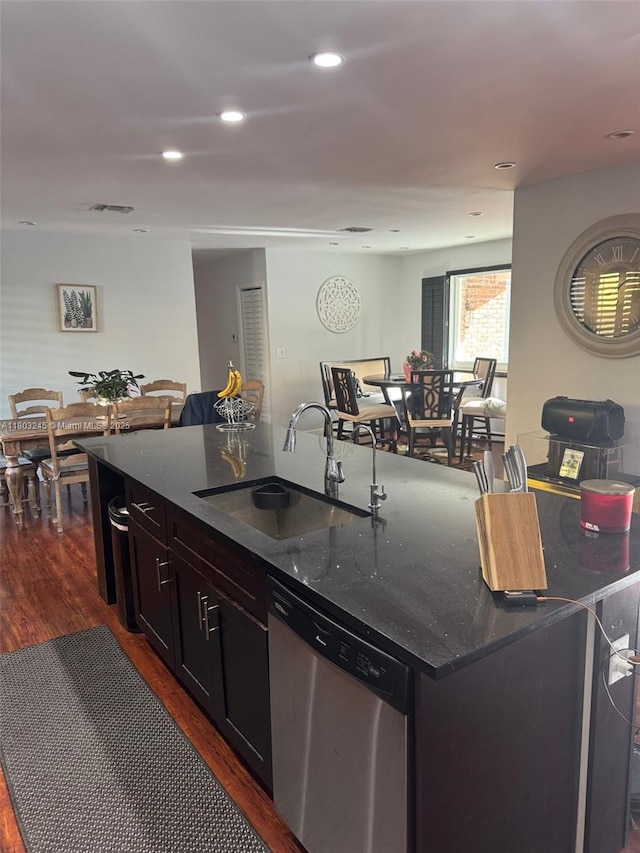 111 SW 24th Ave, Miami, FL 33135 - kitchen featuring a sink, dishwasher, dark wood-style floors, dark stone countertops, and an island with sink
