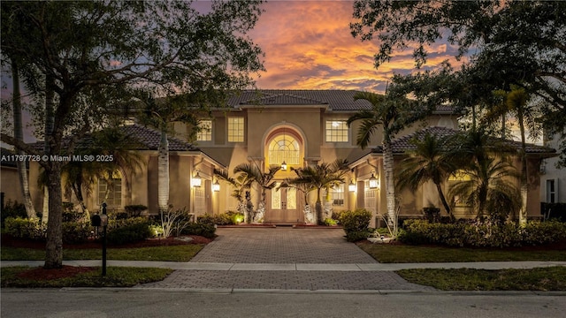 3837 E Coquina Way, Weston, FL 33332 - mediterranean / spanish house with stucco siding, decorative driveway, and a tiled roof