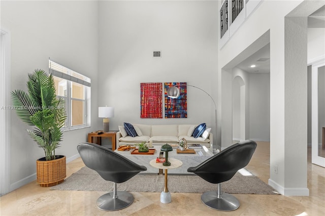 3837 E Coquina Way, Weston, FL 33332 - living area featuring a towering ceiling, arched walkways, and baseboards