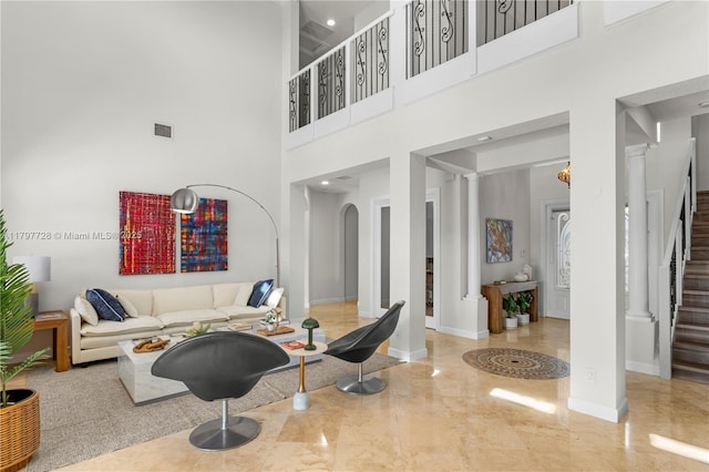 3837 E Coquina Way, Weston, FL 33332 - living room with arched walkways, marble tiled flooring, stairs, a high ceiling, and ornate columns