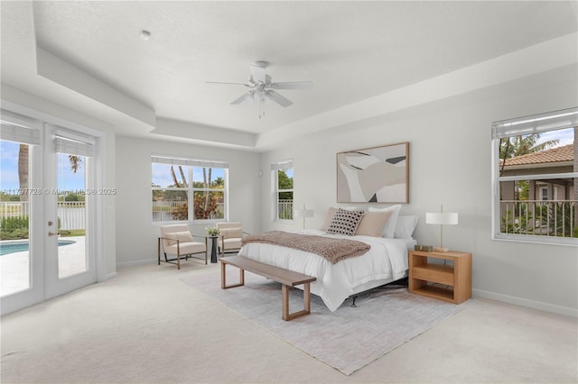 3837 E Coquina Way, Weston, FL 33332 - bedroom featuring access to outside, light carpet, a tray ceiling, and multiple windows