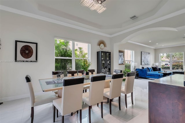 15331 SW 20th St, Miramar, FL 33027 - dining area with a tray ceiling, arched walkways, light tile patterned floors, a chandelier, and ornamental molding