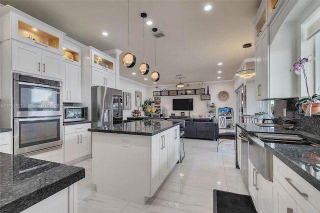 15331 SW 20th St, Miramar, FL 33027 - kitchen featuring appliances with stainless steel finishes, a kitchen island, backsplash, light marble finish floors, and recessed lighting