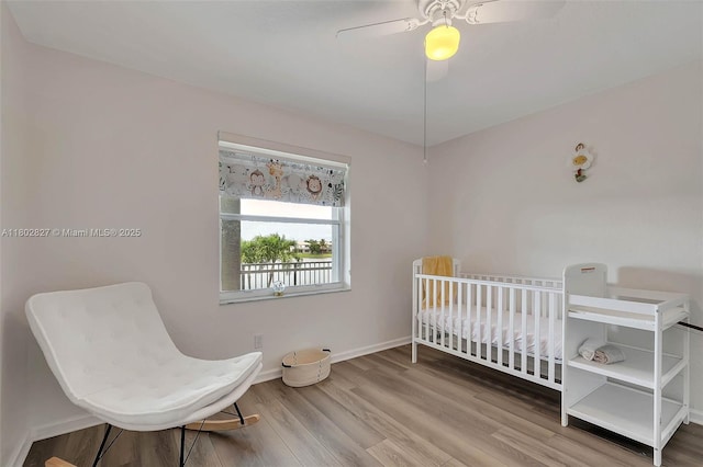 15331 SW 20th St, Miramar, FL 33027 - bedroom featuring wood finished floors, a nursery area, ceiling fan, and baseboards