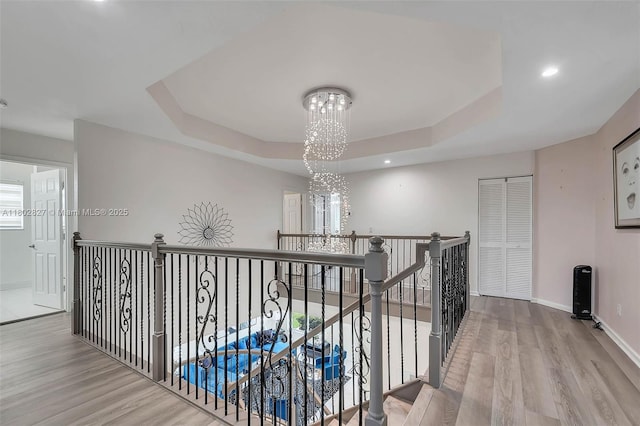15331 SW 20th St, Miramar, FL 33027 - hall featuring a chandelier, an upstairs landing, wood finished floors, baseboards, and a tray ceiling
