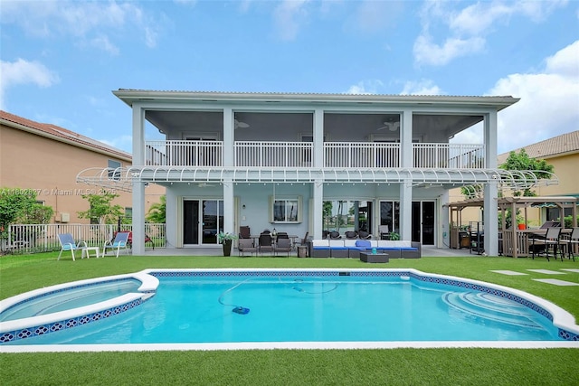 15331 SW 20th St, Miramar, FL 33027 - back of property with an outdoor hangout area, a patio area, a sunroom, and a pool with connected hot tub