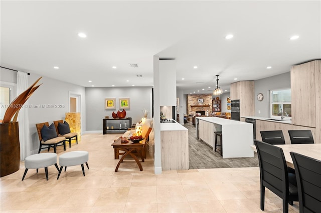 6809 Mentone St, Coral Gables, FL 33146 - living area with recessed lighting, light tile patterned floors, and a fireplace