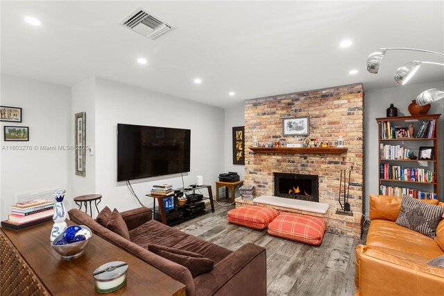 6809 Mentone St, Coral Gables, FL 33146 - living area with wood finished floors, recessed lighting, and a brick fireplace