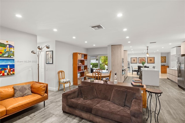 6809 Mentone St, Coral Gables, FL 33146 - living room with light wood-style floors, recessed lighting, and baseboards