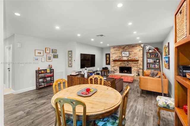 6809 Mentone St, Coral Gables, FL 33146 - dining room with dark wood-type flooring, recessed lighting, baseboards, and a brick fireplace