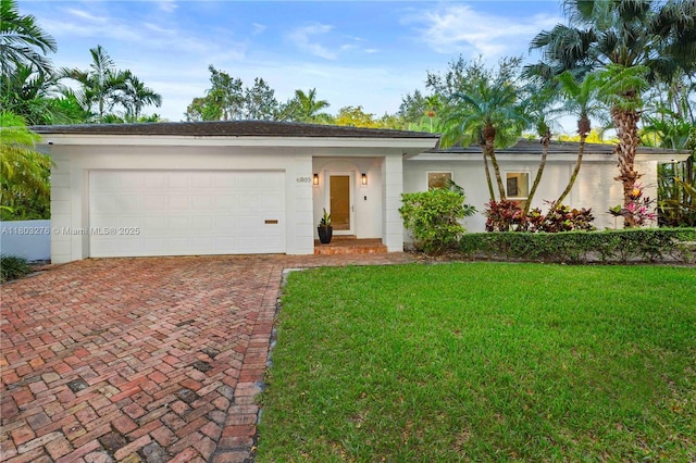 6809 Mentone St, Coral Gables, FL 33146 - single story home with decorative driveway, a front yard, a garage, and stucco siding