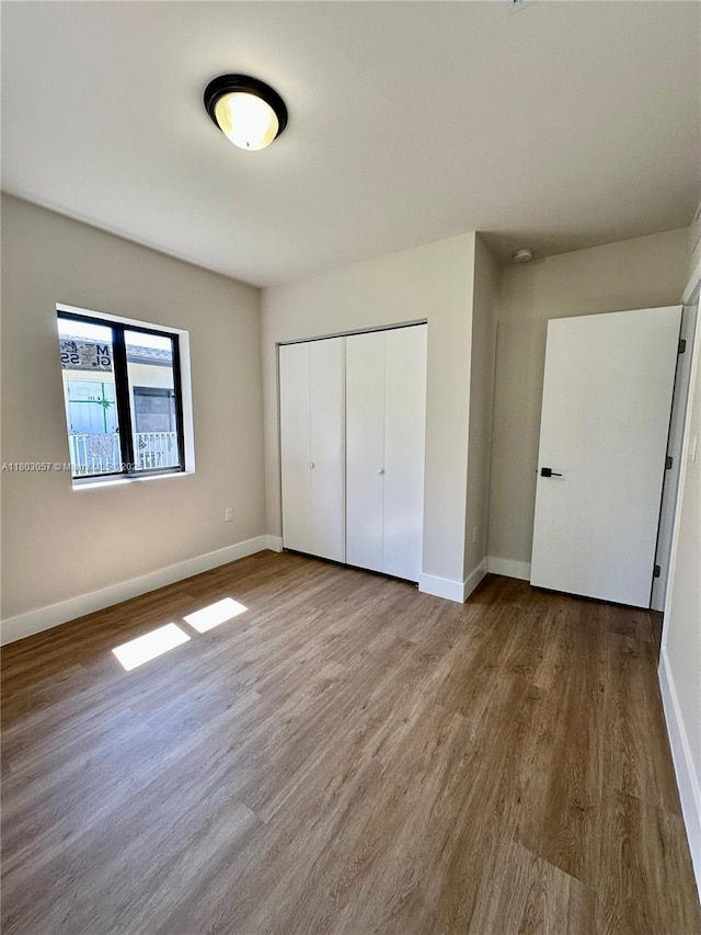 1769 NW 41st St, Miami, FL 33142 - unfurnished bedroom featuring a closet, wood finished floors, and baseboards