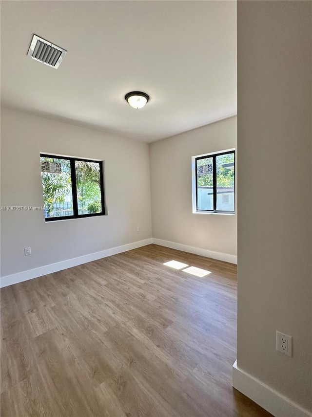 1769 NW 41st St, Miami, FL 33142 - empty room with wood finished floors and baseboards