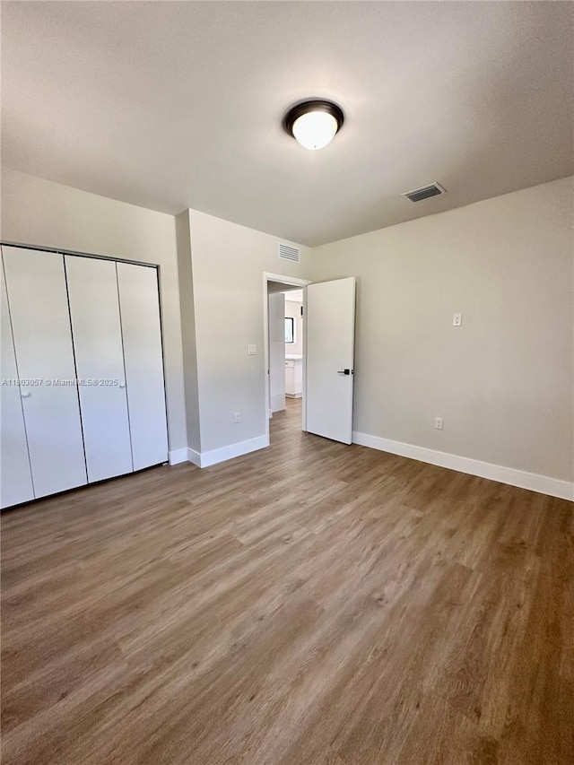 1769 NW 41st St, Miami, FL 33142 - unfurnished bedroom with baseboards, wood finished floors, and a closet