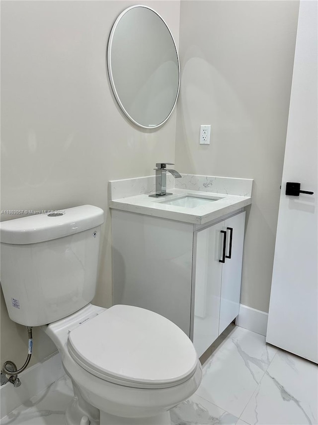 1769 NW 41st St, Miami, FL 33142 - bathroom featuring marble finish flooring, toilet, vanity, and baseboards