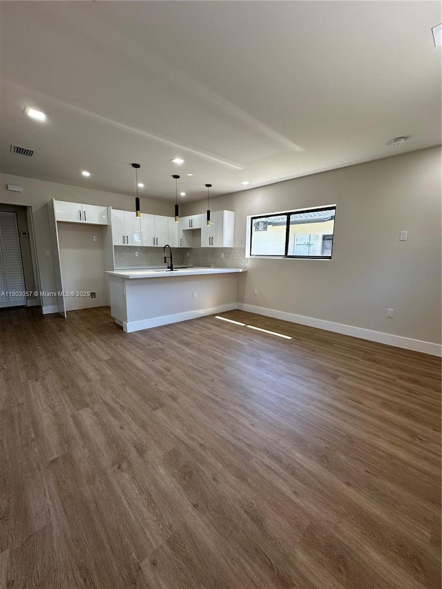 1769 NW 41st St, Miami, FL 33142 - unfurnished living room featuring a sink, recessed lighting, baseboards, and dark wood finished floors