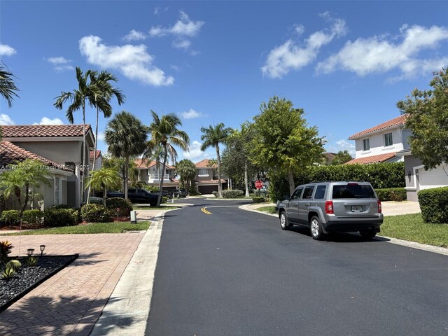 14737 SW 132nd Ct, Miami, FL 33186 - view of asphalt street with traffic signs, a residential view, and curbs
