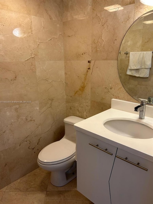 100 Bayview Dr Unit 309, Sunny Isles Beach, FL 33160 - bathroom with tile walls, vanity, and toilet