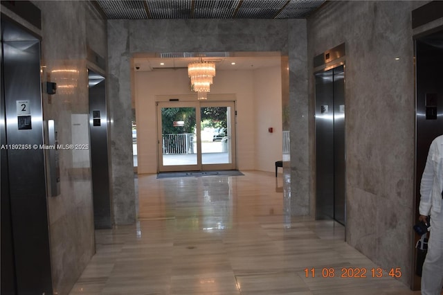 100 Bayview Dr Unit 309, Sunny Isles Beach, FL 33160 - corridor featuring elevator and a chandelier