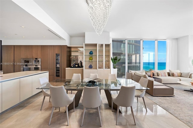 18501 Collins Ave Unit 501, Sunny Isles Beach, FL 33160 - dining room with a chandelier, light tile patterned flooring, and a wall of windows