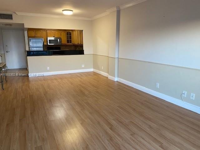 1455 N Treasure Dr Unit 4N, North Bay Village, FL 33141 - unfurnished living room featuring crown molding, wood finished floors, and baseboards