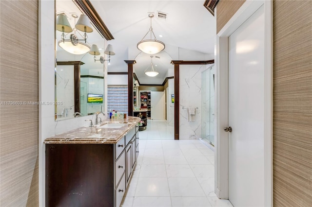 bathroom featuring a marble finish shower, vanity, and marble look tiles