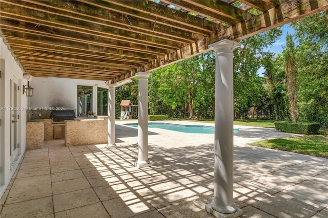 view of patio / terrace featuring area for grilling, a pergola, and an outdoor pool