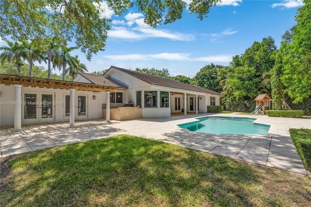 9825 SW 63rd Ct, Pinecrest, FL 33156 - rear view of property with french doors, a patio, stucco siding, and an outdoor pool