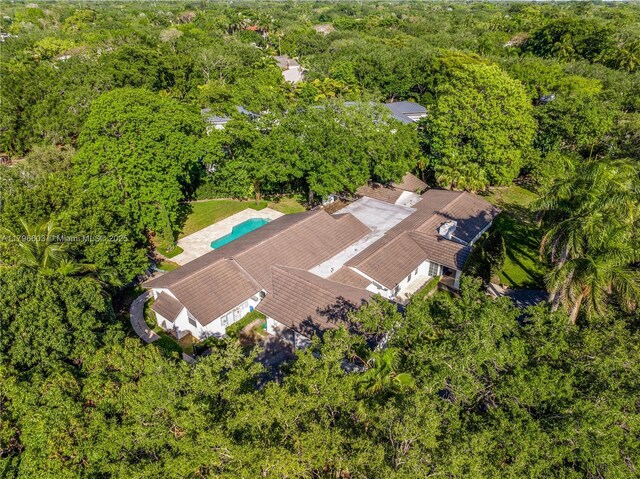 view of subject property featuring a heavily wooded area