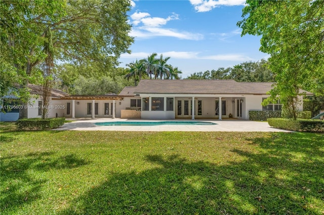 9825 SW 63rd Ct, Pinecrest, FL 33156 - back of house featuring french doors, a patio, a yard, an outdoor pool, and stucco siding