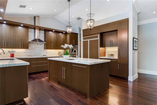 kitchen featuring wall chimney range hood, a sink, dark wood-style floors, vaulted ceiling, and recessed lighting
