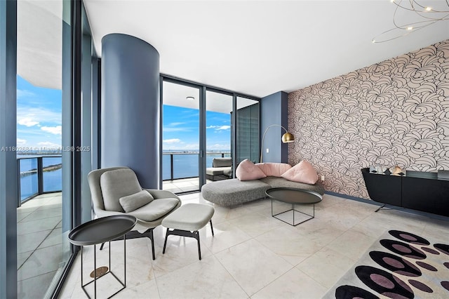 480 NE 31st St Unit 4207, Miami, FL 33137 - living area with expansive windows, a water view, and healthy amount of natural light