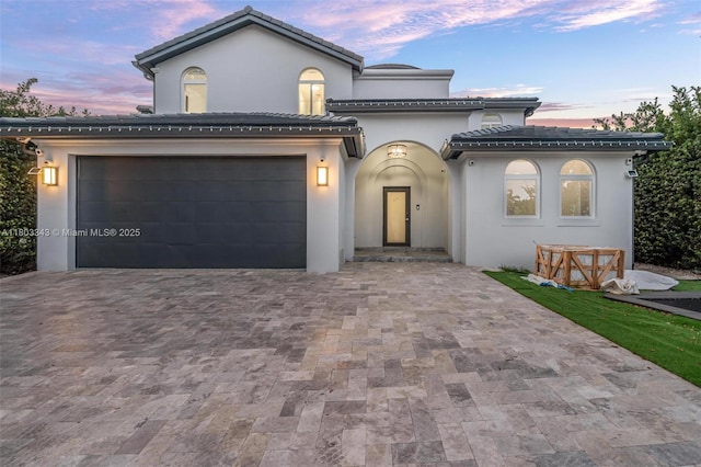 5978 Alton Rd, Miami Beach, FL 33140 - mediterranean / spanish home featuring decorative driveway, stucco siding, and a tiled roof