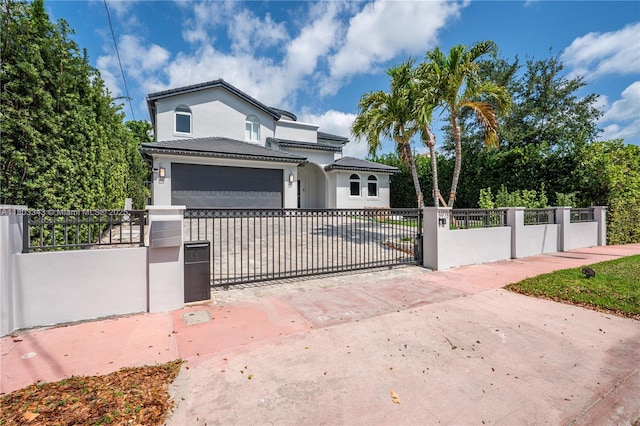 5978 Alton Rd, Miami Beach, FL 33140 - view of front facade with stucco siding, a fenced front yard, and a gate