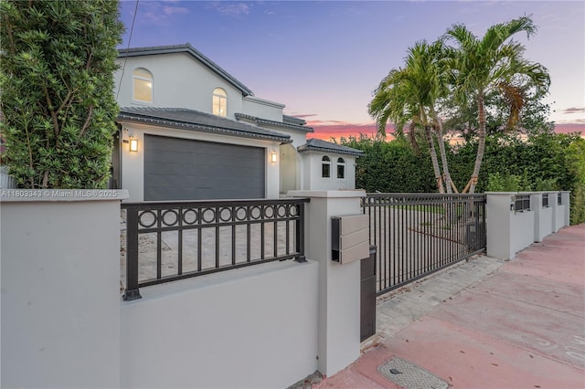 5978 Alton Rd, Miami Beach, FL 33140 - gate at dusk featuring a fenced front yard