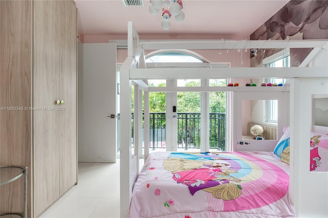 5978 Alton Rd, Miami Beach, FL 33140 - bedroom with multiple windows, access to exterior, french doors, and light tile patterned floors